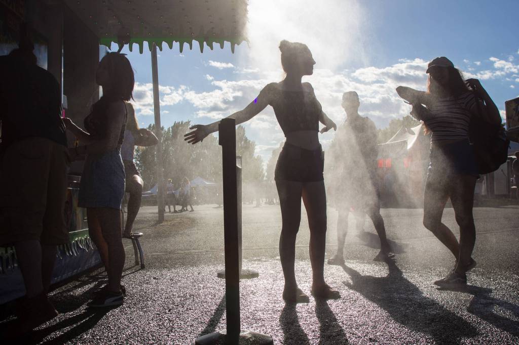 Festivalgoers cool off from the heat on the first of three days during the annual Sasquatch! Music Festival on Friday, May 26, 2017 in George, Wa. (Daniella Beccaria / For the Herald )