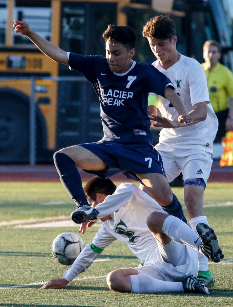 Glacier Peak&rsquo;s Owen Padilla (7) leaps over Todd Beamer&rsquo;s Luke Gregg during a state 4A semifinal game at Sparks Stadium in Puyallup on Friday, May 26. After the two teams battled to a 2-2 draw in regulation, Todd Beamer won after a penalty shootout. (Ian Terry / The Herald)