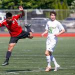Snohomish&rsquo;s Eduardo Torralba-Barragan (left) heads the ball up field as Roosevelt&rsquo;s Vincent Duyungan looks on during the 3A State Championship at Sparks Stadium in Puyallup on Saturday, May 27. Roosevelt beat Snohomish 2-0. (Ian Terry / The Herald)