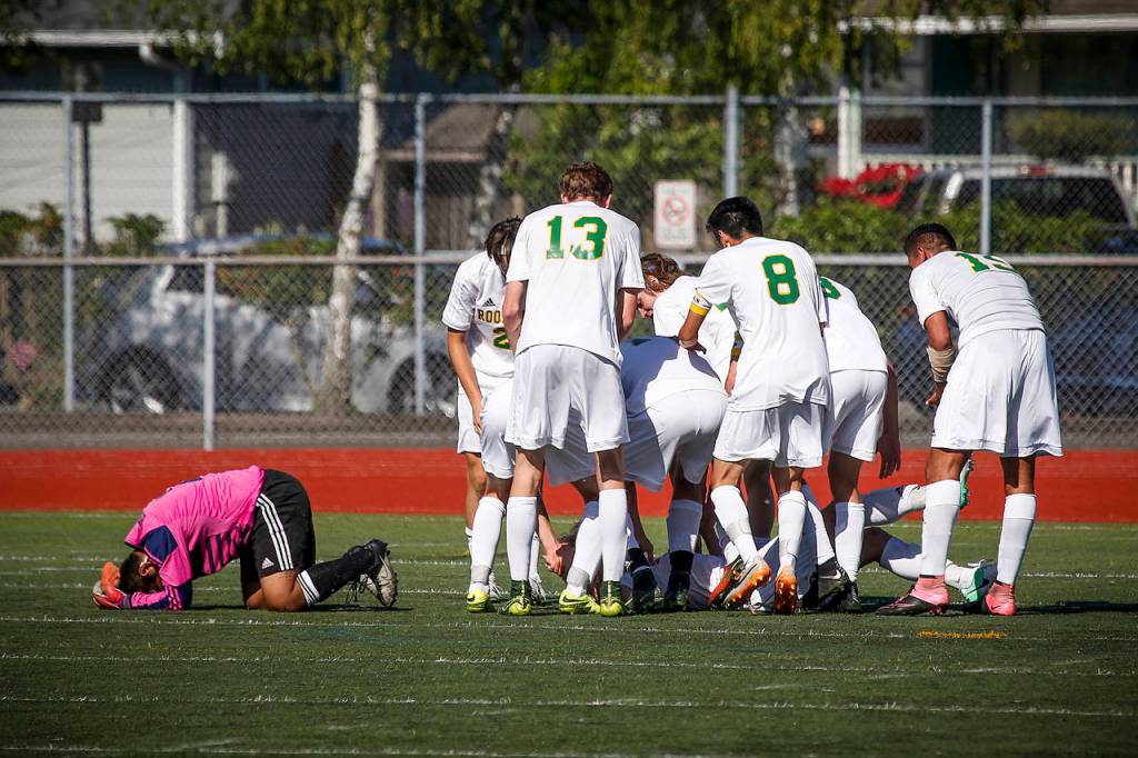 Snohomish goalkeeper Michael Herrera (left) lays on the field as Roosevelt celebrates a goal late in the second half of the 3A State Championship at Sparks Stadium in Puyallup on Saturday, May 27. Roosevelt beat Snohomish 2-0. (Ian Terry / The Herald)