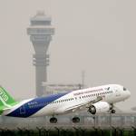 A Chinese-made C919 passenger jet takes off on its first flight at Pudong International Airport in Shanghai on Friday. (AP Photo/Andy Wong, Pool)