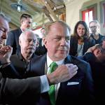 Elaine Thompson / associated press                                Seattle Mayor Ed Murray is surrounded and embraced by supporters, some in tears, Tuesday.