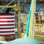 Boeing employees work on the vertical stabilizer of a 767 cargo plane in the Boeing factory on May 17 in Everett. Boeing cut nearly 1,600 jobs in the state in April, the biggest one month drop since January 2003. (Andy Bronson / The Herald)