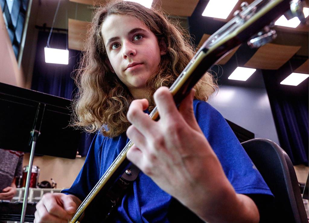 Music prodigy Elijah Croyle, 14, practices on an electric guitar at Valley View Middle School in Snohomish. He recently wrote a breezy Brazilian-style jazz samba, which was performed in March by a professional jazz band in Seattle. Elijah was there to explain his work. (Dan Bates / The Herald)