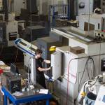 Surrounded by machines worth hundreds of thousand of dollars, C&C machinist Todd Hardman programs a machine to mill a clevis at Cobalt Enterprises&rsquo; new building Wednesday in Lake Stevens. (Andy Bronson / The Herald)