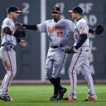 Baltimore center fielder Adam Jones (10) celebrates with right fielder Craig Gentry (right) and left fielder Joey Rickard after the Orioles defeated the Boston Red Sox 5-2 Monday night at Fenway Park in Boston. (AP Photo/Charles Krupa)