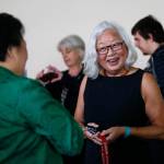 After speaking at Everett Community College about her mother&rsquo;s wartime experience in Japanese internment camps Tuesday, Mayumi Tsutakawa (facing) is greeted by Van Dinh-Kuno, executive director of Refugee and Immigrant Services Northwest. (Dan Bates / The Herald)