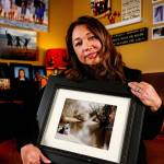 Mayume Carelli&rsquo;s home is filled with images of the people she loves, including the one she is holding of her dad, Dan Varnell, at his favorite fishing hole on the Pilchuck River. It is where he was murdered by Gail Brashear in 1996. (Dan Bates / The Herald)