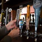 A metal beer tap handle is screwed into a tap at The Independent on Hewitt Avenue in Everett. (Andy Bronson / The Herald)