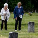 Inajean Buchanan (left) and Frankie Nations-Bryson walk through the Darrington Cemetery together on May 17. Darrington will celebrate the 100th Anniversary of their historic cemetery on Memorial Day. (Ian Terry / The Herald)
