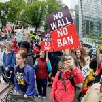 Protesters wave signs and chant during a demonstration against President Donald Trump&rsquo;s revised travel ban on Monday outside a federal courthouse in Seattle. (AP Photo/Ted S. Warren)