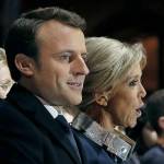 Incoming French President Emmanuel Macron (left) and his wife, Brigitte Macron, sing the national anthem after he delivered a speech in front of the Pyramid at the Louvre Museum in Paris on Sunday. (Thomas Samson/Pool Photo via AP)