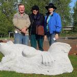 Artist George Pratt (left) stands with Arlington Arts Council President Sarah Arney and Treasurer Jean Olson with the frog statue he created and the Arts Council donated for Haller Park. (Contributed photo)