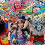 Members of Ce Atl, an Aztec-inspired spiritual and cultural preservation group, dance near the front of a march for worker and immigrant rights at a May Day event Monday in Seattle. (AP Photo/Elaine Thompson)