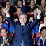 South Korean candidate Moon Jae-in of the Democratic Party reacts as his party leaders and members watch results of the presidential election in Seoul on Tuesday. Exit polls forecast that liberal Moon would win the election to succeed ousted President Park Geun-hye. (AP Photo/Ahn Young-joon)
