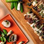 Grilled scallops drizzled with a classic Mediterranean combination of lemon, extra-virgin olive oil and herbs. (Photo by Goran Kosanovic for The Washington Post)