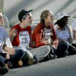 Protesters lock arms as they block a driveway at the U.S. Citizen and Immigration Services building in San Francisco on Monday. (AP Photo/Jeff Chiu)