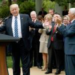 President Donald Trump, accompanied by GOP House members, speaks in the Rose Garden of the White House in Washington on Thursday after the House pushed through a health care bill. (AP Photo/Evan Vucci)