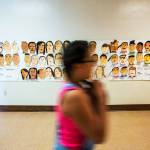 A poster of self-portraits hand-painted by students is displayed in a hallway at Hoover Elementary School in Yakima. (Shawn Gust / Yakima Herald-Republic)