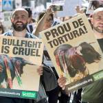 Protesters carry banners during an anti bullfighting demonstration march in Madrid, Spain, on Saturday, May 13. Thousands marched though the center of the city to call for a ban of bullfighting. Banner on right reads &lsquo;Stop the torture&rsquo;. (AP Photo/Paul White)