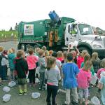 Dutch Hill Elementary School students bring their collection of milk jugs to a Waste Management truck for recycling on April 20 for an Earth Day event. (Contributed photo)
