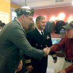 Chris Szarek, director of Edmonds Community College&rsquo;s Veterans Resource Center, and Lt. Cmdr. Brad Coleman of Naval Station Everett greet an unidentified World War II veteran at the May 6 grand opening of the Northwest Veterans Museum in Lynnwood. (Contributed photo)