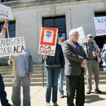 Members of Citizen Action Organizing Cooperative of Western Wisconsin rally in support of the Affordable Care Act outside the Federal Courthouse in Eau Claire, Wisconsin, on Thursday, May 4. (Dan Reiland /The Eau Claire Leader-Telegram via AP)