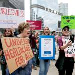 In March 24 photo, protesters gather across the Chicago River from Trump Tower to rally against the repeal of the Affordable Care Act, in Chicago. (AP Photo/Charles Rex Arbogast, File)
