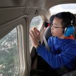 Tom Bodin takes a free ride in a Cessna 182 Skylane during Aviation Day at Paine Field in 2014. This year&rsquo;s event is set for May 20. (Herald file photo)