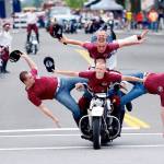 Members of the Seattle Cossacks motorcycle team perform a stunt at the Fourth of July parade in downtown Everett in 2013. (Herald file photo)