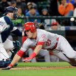 The Angels&rsquo; Mike Trout (right) slides safely into home ahead of the throw to Mariners catcher Mike Zunino during the fifth inning of a game May 2, 2017, in Seattle. (AP Photo/Elaine Thompson)