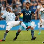 Sporting Kansas City defender Jimmy Medranda (94) kicks the ball away from Sounders midfielder Jordy Delem (21) during an MLS match on May 17, 2017, at Children&rsquo;s Mercy Park in Kansas City, Kan. (Nick Tre. Smith/The Kansas City Star via AP)