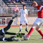Archbishop Murphy&rsquo;s Matt Williams (right) gathers a rebound from East Valley&rsquo;s Chris Kirby to score a goal during the 2A state soccer championship match on May 27, 2017, at Sunset Chev Stadium in Sumner. (Kevin Clark / The Herald)