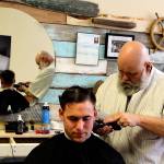 Yondersea owner Kevin Bell gives Petty Officer 2nd Class Joshua Grant a close cut at his new downtown Oak Harbor barber shop. (Photo by Patricia Guthrie/Whidbey News-Times)