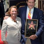 In this May 24, 2010, photo provided by ESPN, sportscaster Chris Berman stands with his wife, Katherine, after receiving his star on the Hollywood Walk of Fame in Los Angeles. The wife of longtime ESPN broadcaster Chris Berman died in a traffic crash in Connecticut, the sports network&rsquo;s president confirmed Wednesday. (Scott Clarke/ESPN Images via AP)