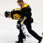 Pittsburgh&rsquo;s Sidney Crosby (87) is helped off the ice after being injured during the first period of Game 3 of the Penguins&rsquo; NHL Stanley Cup Eastern Conference semifinal series against the Washington Capitals. (AP Photo/Gene J. Puskar)