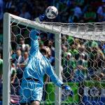 Seattle goalkeeper Stefan Frei leaps to tip a ball over the cross bar during the first half of the Sounders&rsquo; MLS match against the Portland Timbers on Saturday in Seattle. The Sounders won 1-0. (AP Photo/Ted S. Warren)