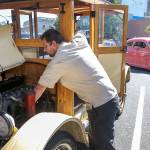 Allen McCutchen works on his 1922 Buick during the newly restored Cruzin Colby Sunday afternoon in downtown Everett on May 28, 2017. (Kevin Clark / The Herald)