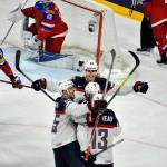 U.S. forward Anders Lee (center) celebrates with teammates after scoring a goal in Tuesday&rsquo;s 5-3 win over Russia in a Group A match at the Ice Hockey World Championships in Cologne, Germany. (AP Photo/Martin Meissner)