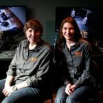Diane (left) and Kate Collison sit in the control room at the Escape Scene in Everett. Videos cameras and microphones allow them to monitor a group&rsquo;s progress and communicate hints if the puzzles are too difficult. (Ian Terry / The Herald)