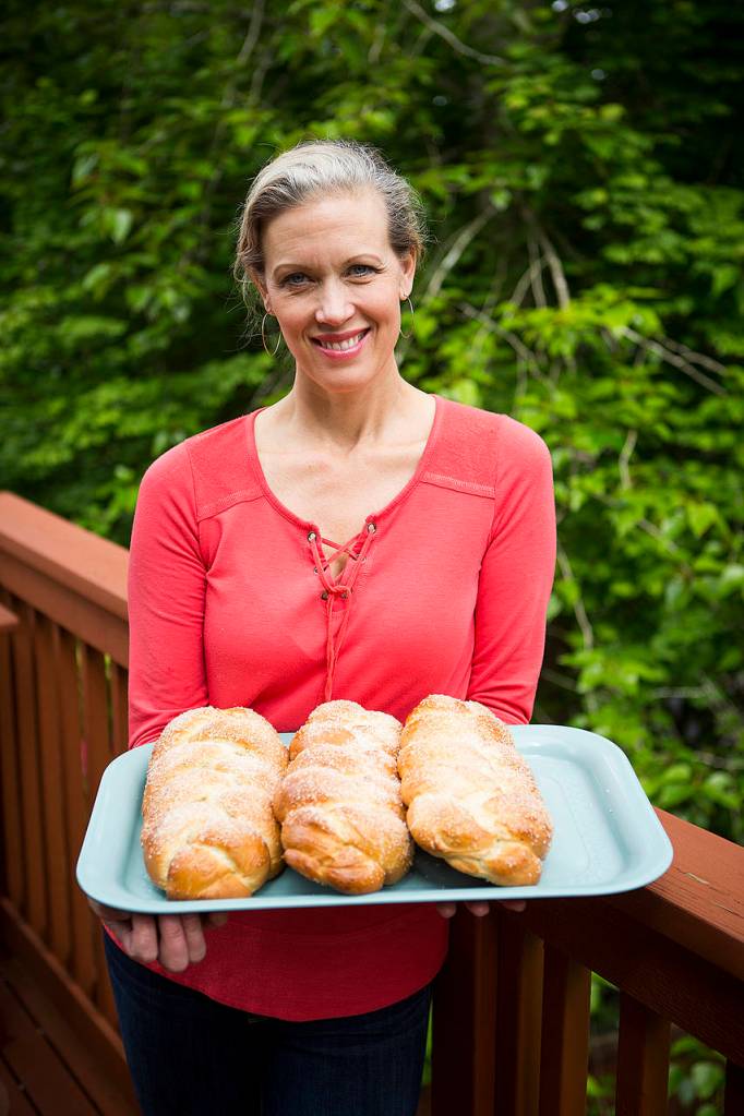 Joyce Sieben holds a fresh batch of her cardamom bread. (Ian Terry / The Herald)