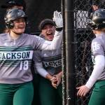 Jackson&rsquo;s Kassidi Dean (left) celebrates a run scored by Sam Klotter during the 4A district championship game against Lake Stevens on May 18, 2017, at Phil Johnson Ballfields in Everett. (Kevin Clark / The Herald)