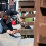 Bryan Gerrish paints a wheelchair ramp at a home in Lowell Saturday morning during the 3rd annual Day of Hope in Everett in May 20, 2017. Sponsored by Gold Creek Community Church, the two-day event drew nearly 1300 volunteers. (Kevin Clark / The Herald)