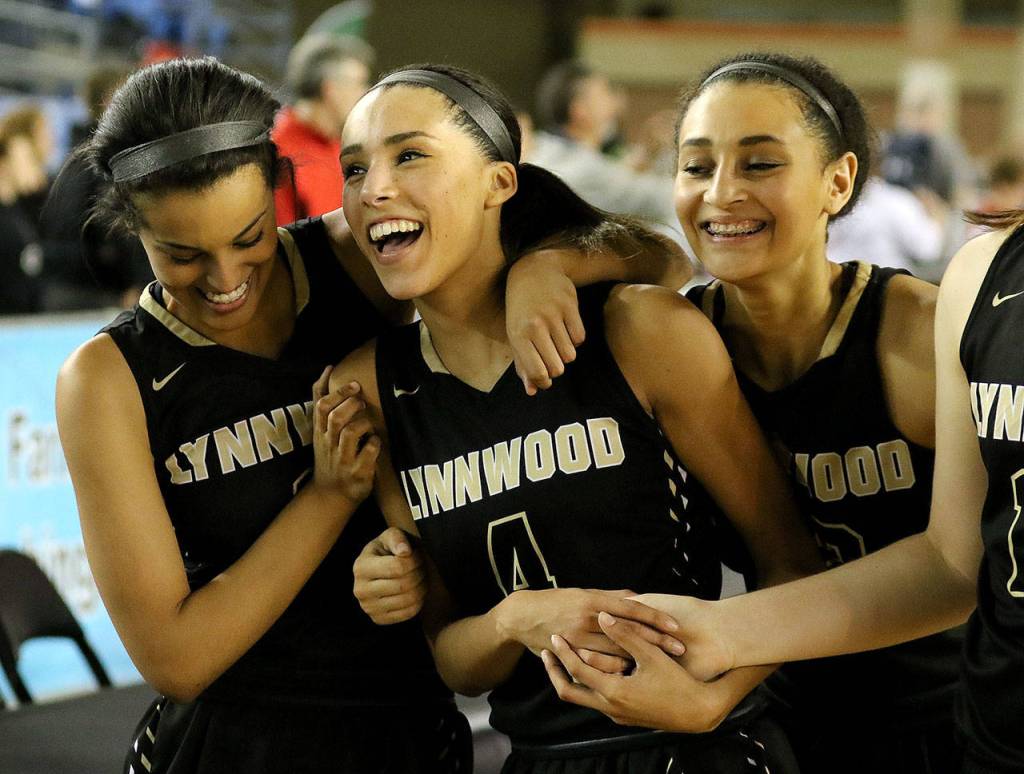 Lynnwood&rsquo;s Abby Yemane (left to right), Lynnwood&rsquo;s Jordyn Edwards and Lynnwood&rsquo;s Kaprice Boston celebrate a playoff win. Edwards improved her grades and SAT score through the Path program. (Kevin Clark / The Herald)