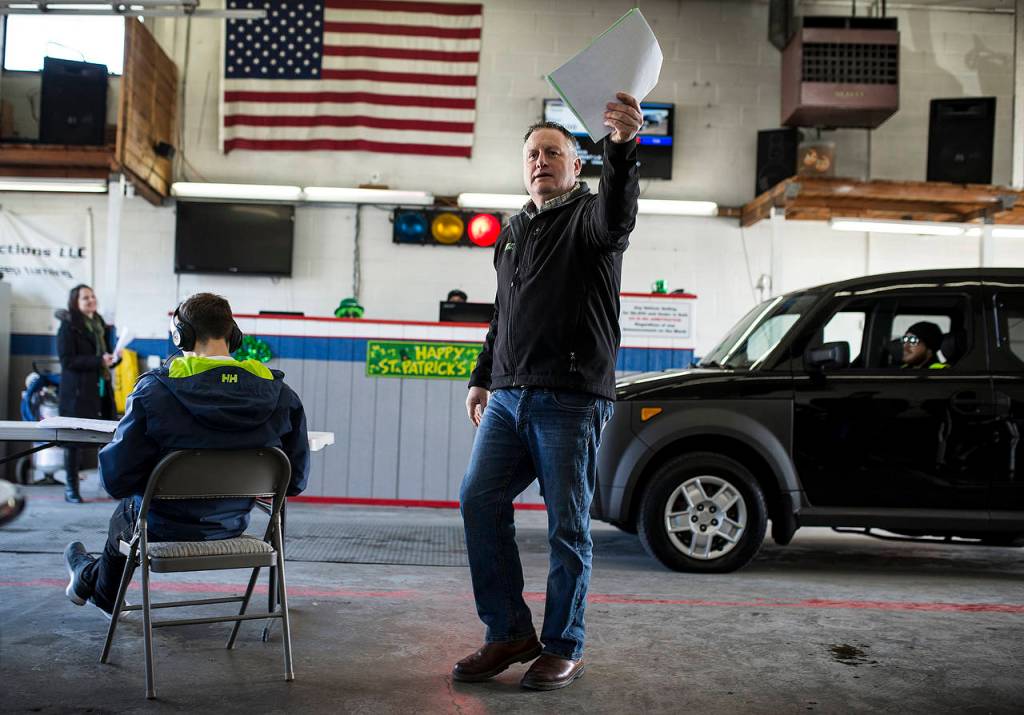 Auctioneer Dennis Lautenbach calls out for a higher bid on a used Honda Element during a dealer auction at Kaman Auctions in Edmonds. (Ian Terry / The Herald)