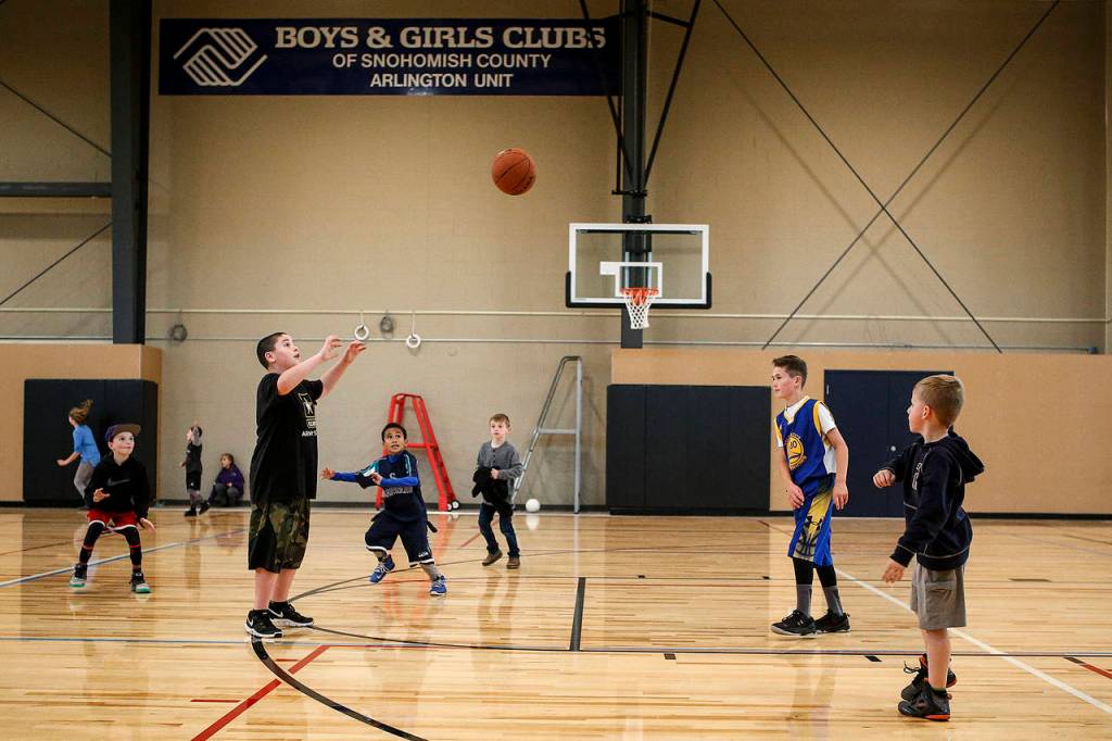 Kids play basketball in the new gym. (Ian Terry / The Herald)