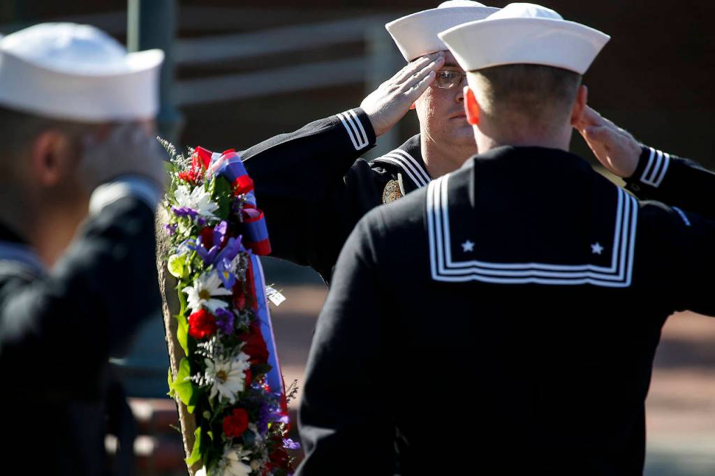 MA3 Steven Andrew Orick Jr. (center left) stands at attention during the wreath presentation at a ceremony held at Naval Station Everett on Thursday marking Memorial Day. (Ian Terry / The Herald)