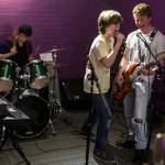 A group performs in a practice space during an open house at the new Lynnwood School of Rock. (Ian Terry / The Herald)