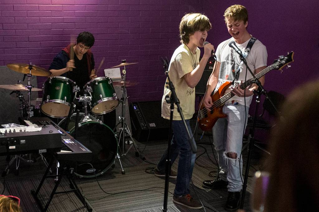A group performs in a practice space during an open house at the new Lynnwood School of Rock. (Ian Terry / The Herald)