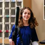 Bassoon in hand and reed moistening between his lips, Elijah Croyle walks from the instrument lockers to his seating position in band practice Wednesday. (Dan Bates / The Herald)